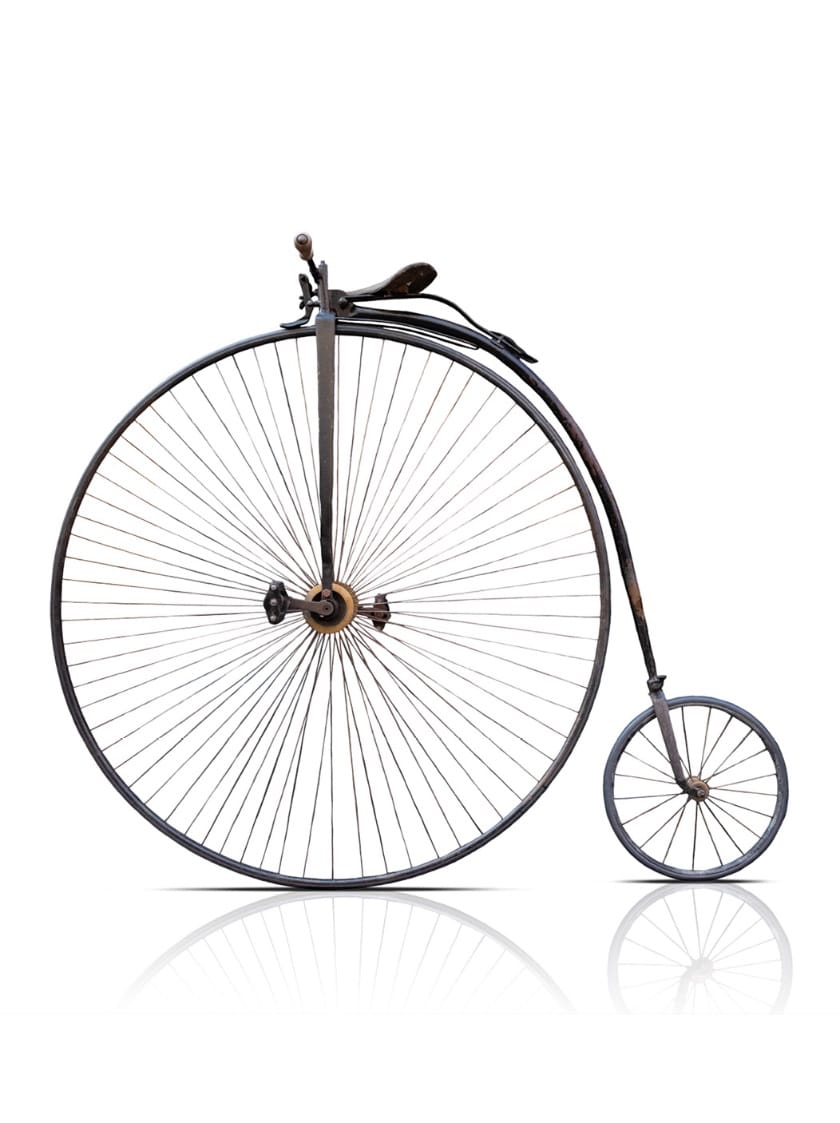 Bicyclette de type Penny-Farthing avec une grande roue avant et une roue arrière beaucoup plus petite.